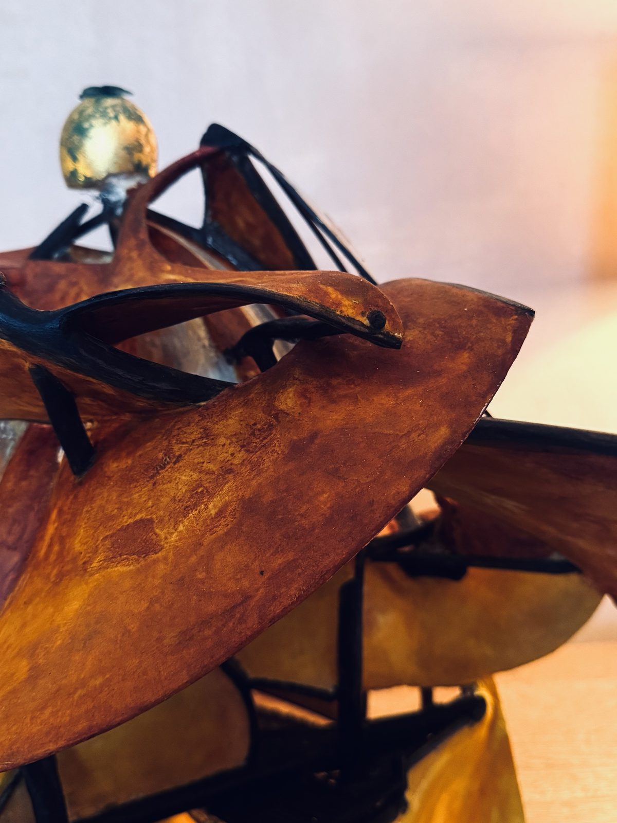 Detail: a bird among the carved, curving planes